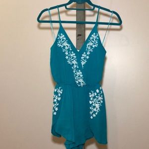 Spaghetti strap teal romper.